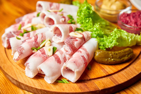Lard with garlic, mustard and horseradish on a wooden board. Close-up, selective focus