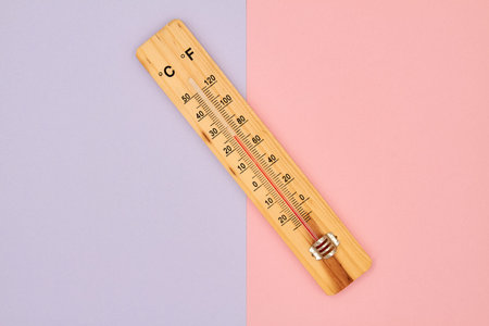 Close-up photo of wooden household alcohol thermometer showing temperature in degrees Celsius on a...