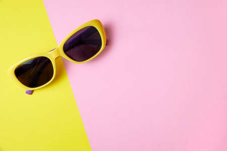 Sunglasses on minimal colorful background with copy spaceの写真素材