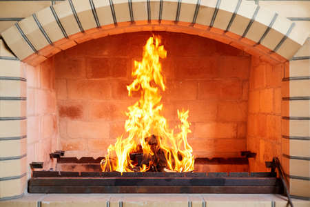 Burning firewood in a brick grill before grilling a kebab. Close-up, selective focusの写真素材