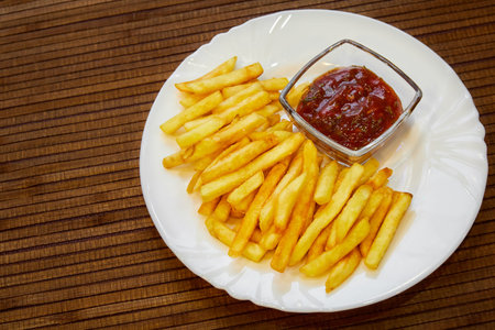 French fries with ketchup on a plate.の写真素材