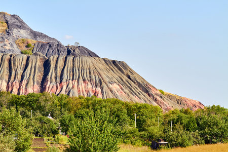 Slagheap in eastern Ukraine with an old house. Industrial waste slag heapsの写真素材