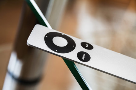 The modern grey steel Remote Control lies on a glass table. Closeup, selective focusの写真素材