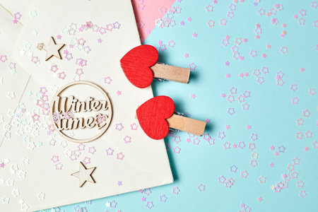 Envelope with decorative clothespins, stars, christmas sparkles and the inscription merry christmas...