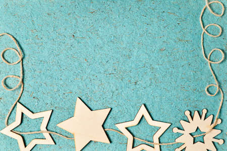 Christmas wooden stars and snowflake on blue design paper backgroundの写真素材
