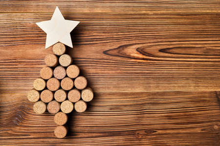 Christmas tree from wine corks with a star on top on a wooden backgroundの写真素材