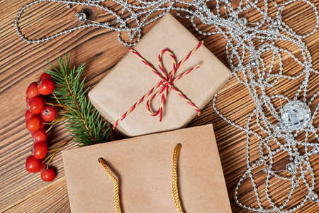 Christmas composition of gift boxes in the paper bag on wooden backgroundの写真素材