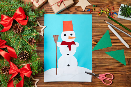 A Christmas greeting card from colored paper made by a childの写真素材