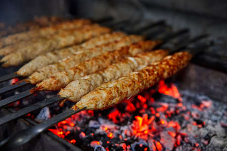 Lula kebab grilled on charcoal. Close up, selective focusの写真素材
