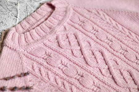 Pink knitted women's sweater with patterns