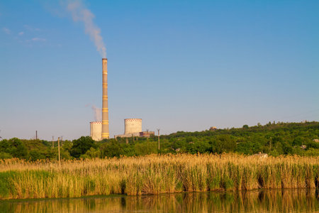 Cogeneration plant (combined heat and power station). Thermal power plant with flue pipe. Industrial...