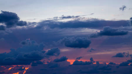 Orange and purple clouds at sunsetの写真素材