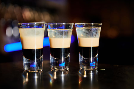 A set of shots b-52 from coffee liqueur, Irish cream and orange liqueurの写真素材
