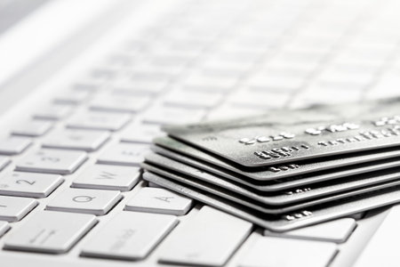 Several bank credit cards on a laptop keyboard