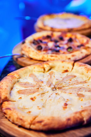 Several different pizzas on a nightclub tableの写真素材
