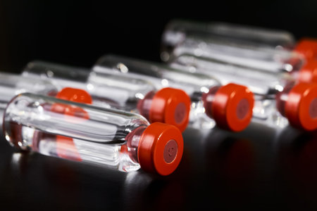 Close-up of medicine for injection in glass vials on a dark background