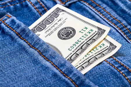 Hundred dollar bills in jeans pocket