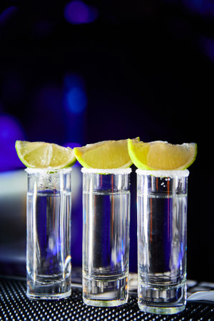 Tequila with lime on the bar of a nightclubの写真素材