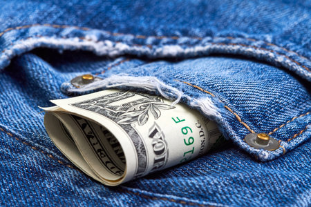 Rolled up one dollar bills in jeans pocket