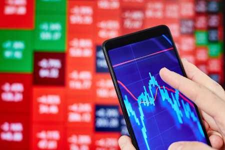 Trader analyzes stock market data in smartphoneの写真素材