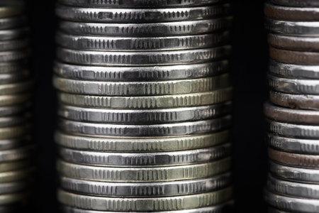 Stacks of metallic coins on a dark background