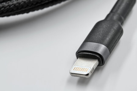 Black micro USB type c data and power cable plug on white background. close up