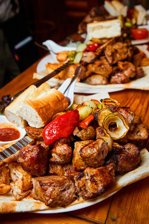 Shish kebab with grilled vegetables, lavash and sauces. Close up, selective focusの写真素材