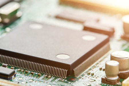 Close-up of computer chip on a part of electronic printed circuit board with sunlight