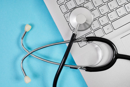 Top view of Phonendoscope or stethoscope on laptop keyboard on blue backgroundの写真素材