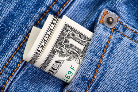 Rolled up one dollar bills in jeans pocketの写真素材