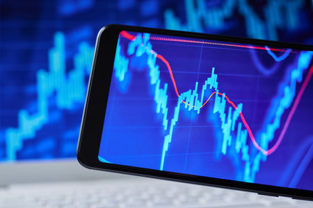 Stock market data in smartphone on the background of stock chartsの写真素材
