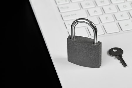 Padlock with a key on a laptop as a concept of protecting information in cyberspaceの写真素材