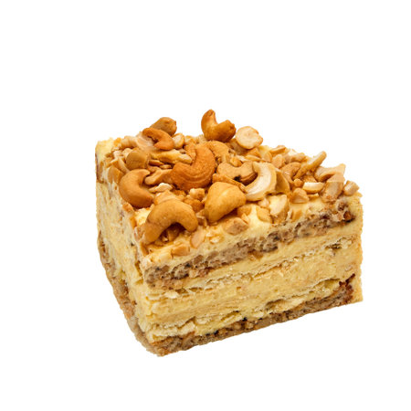 A piece of Cashew cake based on protein layers with cashews, custard and chocolate isolated on whiteの写真素材