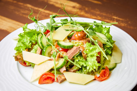Salad with beef tongue, cheese, tomatoes, lettuce and cucumbersの写真素材
