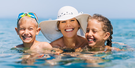 Mother with Kids on Holiday Vacation Swimming Sea Water Blue Oceanの写真素材