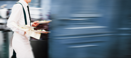 Waiter Serving In Motion On Duty in Restaurant Long Exposureの写真素材