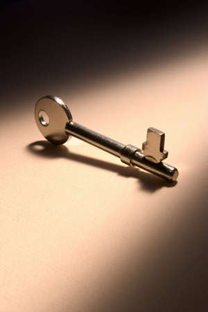 House key with shadow on textured backgroundの写真素材