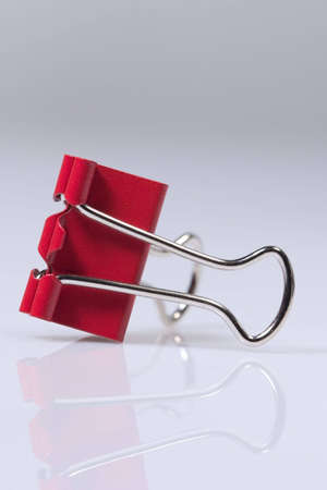 Red fold-back clip on neutral backgroundの写真素材
