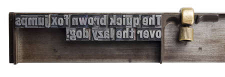 Typesetters composing stick showing well-known paradigm isolated on white backgroundの写真素材