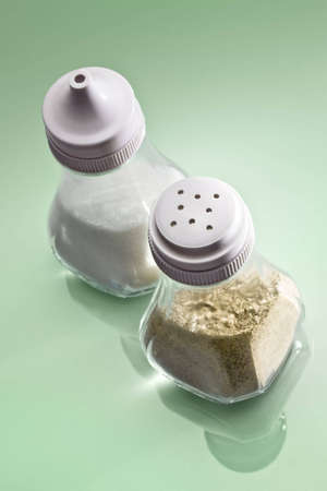 Salt and pepper on reflective surfaceの写真素材