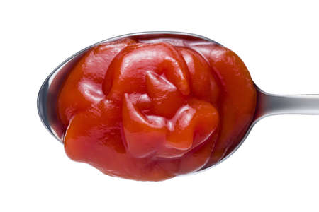 Tomato ketchup on spoon isolated on white backgroundの写真素材