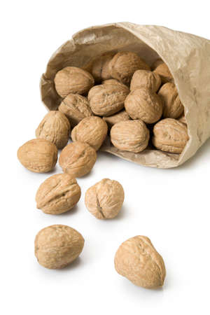 Walnuts spilling from brown paper bagの写真素材