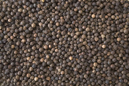 Close-up background of black peppercornsの写真素材