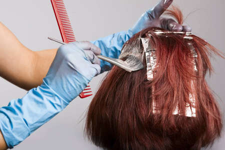 Hairdresser applying colour to customers hairの写真素材