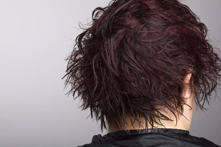 Middle-aged woman at hair salon with wet hair