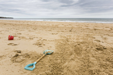 Bucket and spade on deserted beachの写真素材