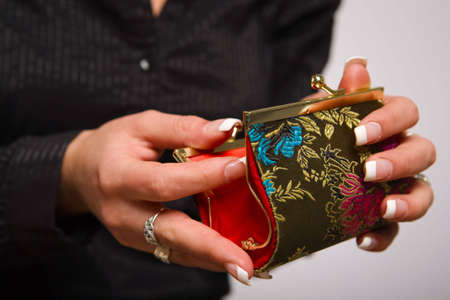 Woman's hands opening empty coin purseの写真素材