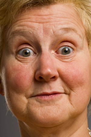 Close-up of mature woman pulling silly face