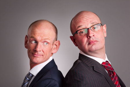 Portrait of two businessmen standing back-to-back