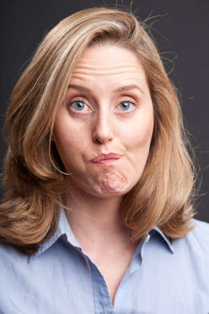 Blonde woman with quizzical facial expressionの写真素材